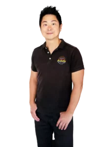 A person wearing a black polo shirt with a colorful Becony V1 logo stands with hands relaxed at their sides.