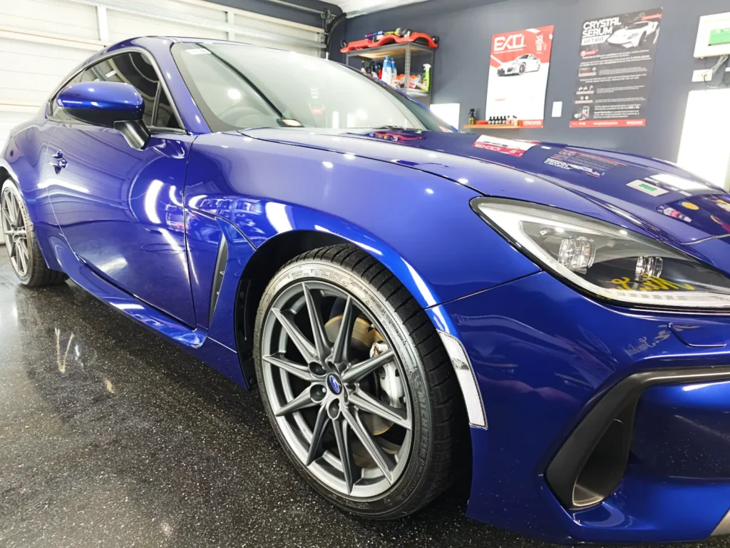 Close up photo of newly detailed blue car | Image for the Car Detailing Company page.