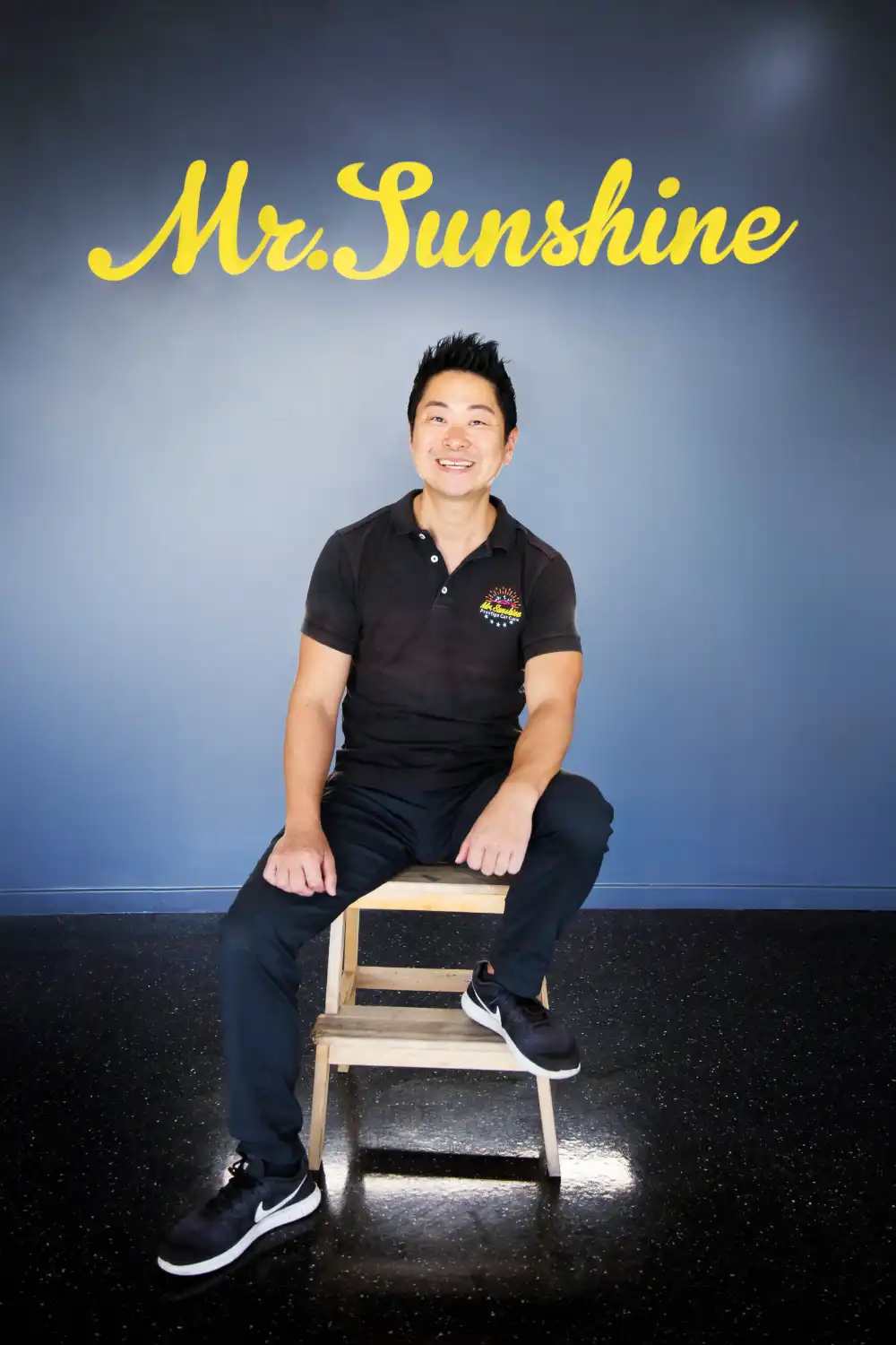 Jason Kim sits on a wooden stool | Featured image for the Jindalee car detailing location page